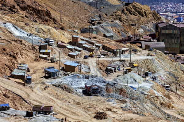 Mining area with scattered huts and lorries in an impassable terrain, The silver mines of Potosi