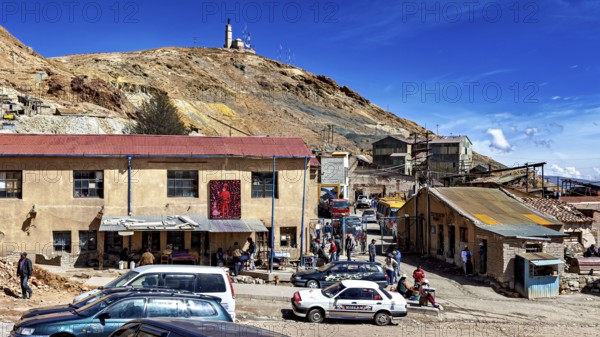 Busy square in front of a mine site with people and cars, The silver mines of Potosi Bolivia