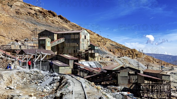 Historic industrial site on a mountainside under a clear blue sky, The silver mines of Potosi