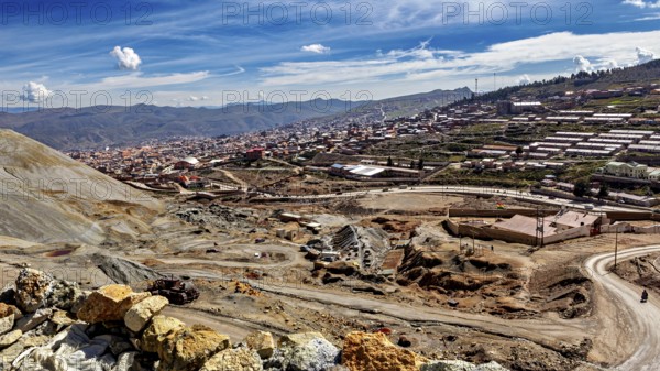 View of a town along a mountainous landscape under a clear blue sky with few clouds, The silver