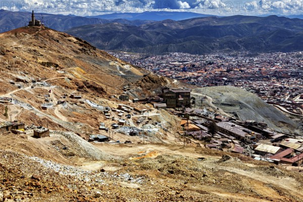 Far-reaching panorama of a city embedded in a mountainous landscape with clouds, The silver mines