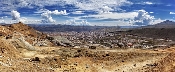 Panoramic view of a vast landscape with mountains and a city under a cloudy sky, view from Silver