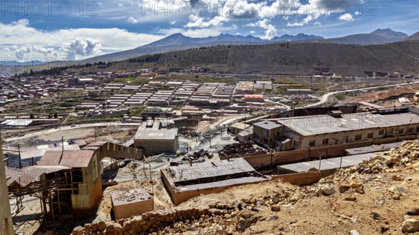 Sweeping views of a valley surrounded by mountains and scattered buildings, The silver mines of