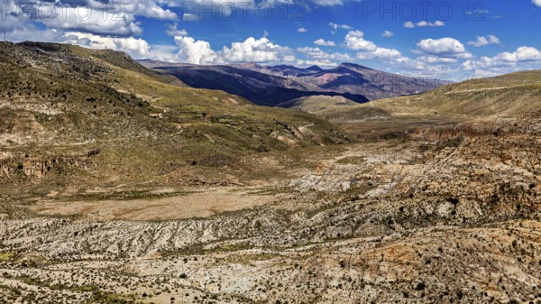 Wide valley in a mountainous region with sparse vegetation, The landscape of the Altiplano in