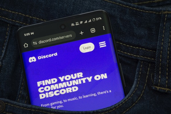 Dhaka, Bangladesh- 03 Oct 2025: A smartphone displaying the Discord web interface peeks out of a