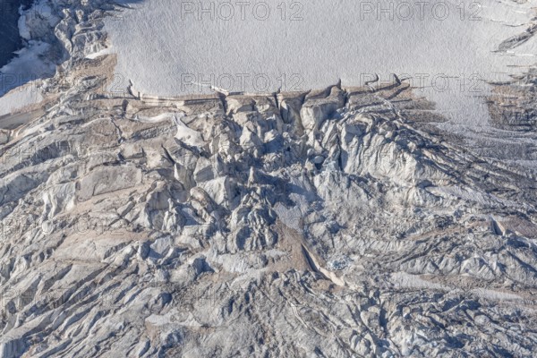 Intricate patterns of ice and rock are showcased in this stunning glacial landscape, revealing the