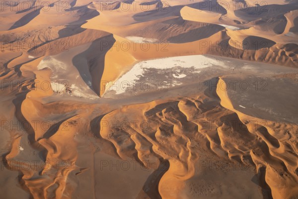 Sand dunes and dry pans in the Namib Desert. In the evening. Aerial view. Namib-Naukluft Park,