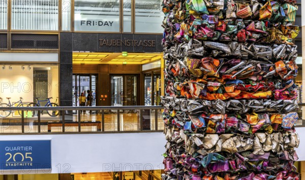 Interior design, artwork made from compressed scrap cars, partially vacant Shopping Quartier 205 in