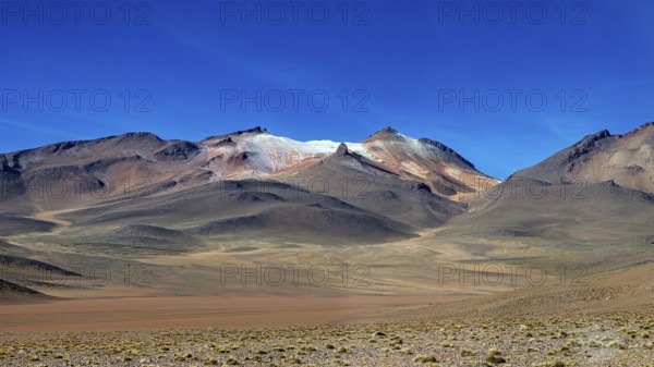Rocky mountains under a deep blue sky in an arid region, The landscape with the volcanoes on the