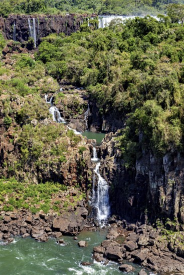 High waterfall with surrounding forest and rocks, harmonious natural scenery, The Iguazu Falls