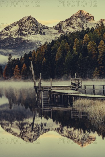Lake Staz near Sankt Moritz in the Engadin in Switzerland. Morning atmosphere with fog in autumn.