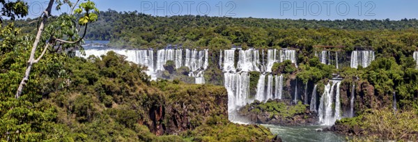 Scenic waterfalls and dense vegetation on a clear day, The Iguazu Falls between Argentina and