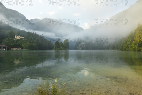 Mystical morning at Königssee in Schönau with boathouses and Christlieger. Sunrise and beautiful