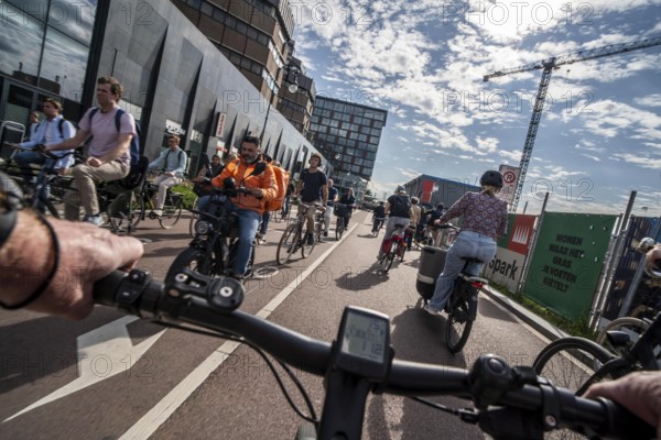 Ride your bike on the central cycle path on Lange Viestraat, Vredenburg, in the city centre of