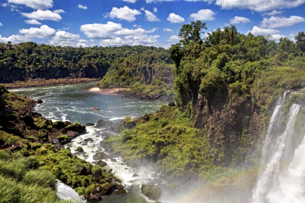 Extensive river landscape with waterfalls and lush riverside vegetation, boat on the water, The