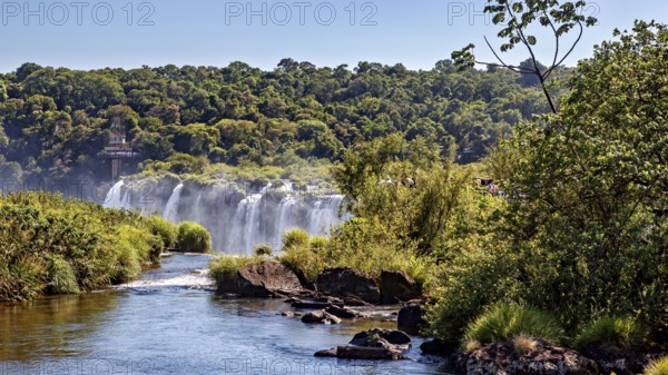 Path to a waterfall, surrounded by trees and vegetation, The Iguazu Falls between Argentina and