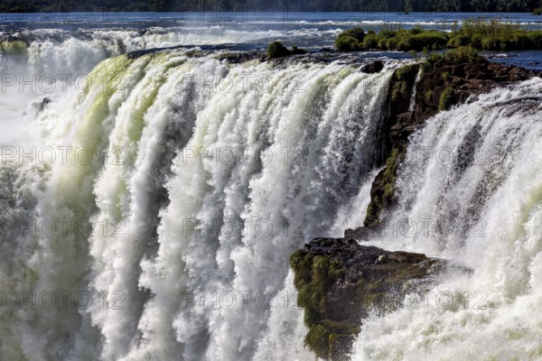 Mighty waterfall with cascading masses of water and swirling spray, The Iguazu Falls between