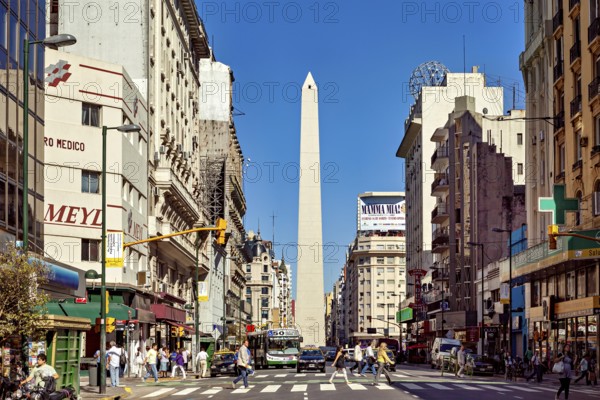A busy street scene in daylight in Buenos Aires with the obelisk in the centre, The great obelisk