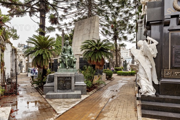 Ornate tomb with statues and angels in a peaceful setting, La Recoleta cemetery in Buenos Aires