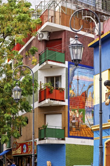 Colourful building with balconies and murals in a lively neighbourhood, the colourful city and