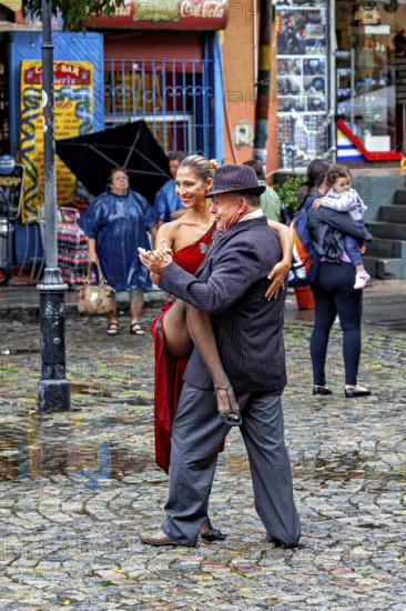 Tango couple in an intimate embrace dancing on a rainy street, surrounded by spectators, The