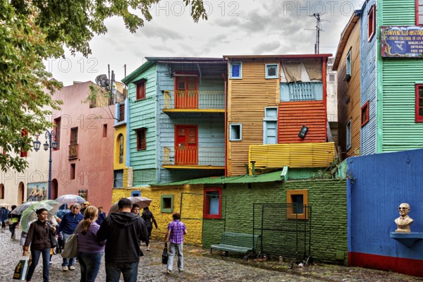 Colourful buildings with people on a cobbled street, lively and creative atmosphere, The colourful