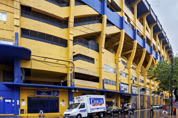 Yellow and blue stadium building on a rainy street, The football stadium of La Bocca of Bocca
