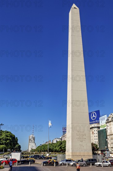 A tall obelisk under a clear sky in Buenos Aires in daylight, flanked by cars, The great obelisk in