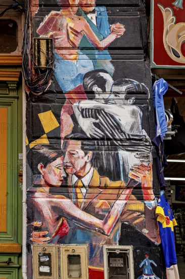 Artistic mural of dancing couples in vibrant colours on a city wall, The colourful city and tango