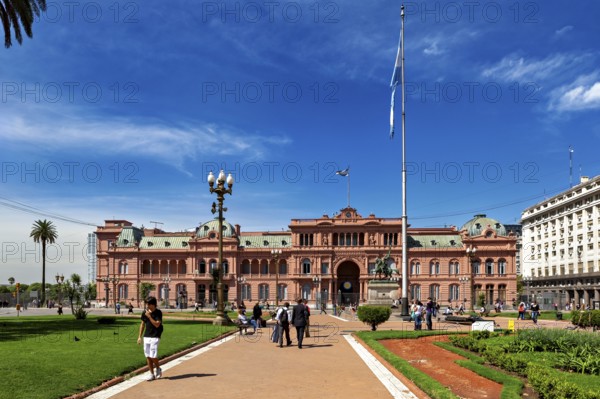 Historic building with surrounding gardens and flag, sunny day in Buenos Aires, The presidential