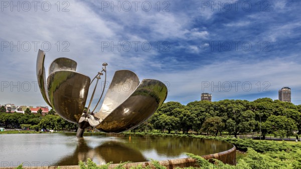 Architectural metal flower in a park with urban backdrop and blue sky, The lotus flower in Buenos
