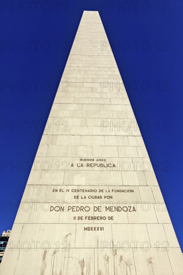 Close-up of an obelisk with engraved inscriptions against a clear blue sky, The great obelisk in