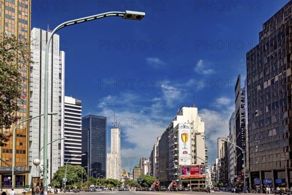 A busy city street with modern skyscrapers and heavy traffic under a blue sky, The city of Buenos