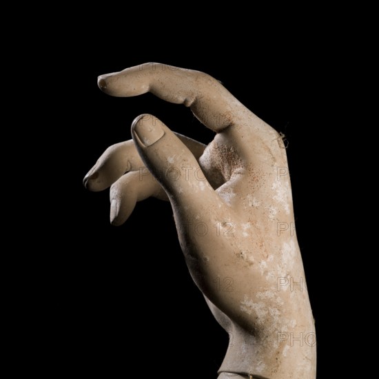 A detailed view of a mannequin hand with fingers slightly curled, creating a graceful pose against