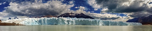 Large-scale panorama of a distant glacier with draped clouds and mountains, The glacier of Perito