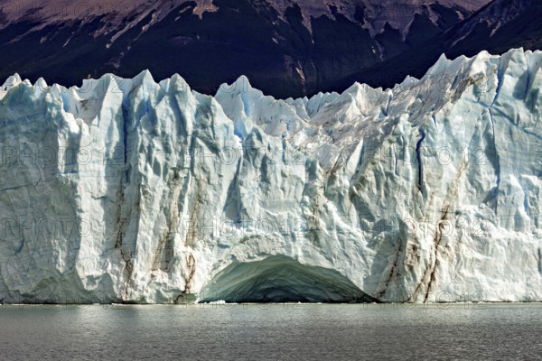 Impressive ice wall of a glacier with clear lines and a blue sky, The glacier of Perito Moreno in