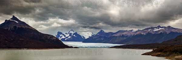 Vast, dramatic landscape in a panoramic format with glaciers and clouds over the horizon, The