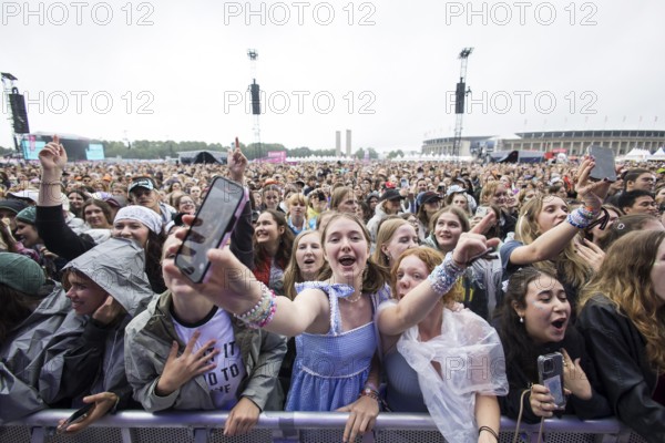 Festival visitors celebrate Mark Ambor's performance at the Lollapalooza Festival in the