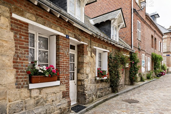 Picturesque old town street with half-timbered houses and blooming flowers in the window boxes, The