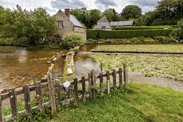Picturesque landscape with river, old stone bridge and traditional houses in the countryside, the