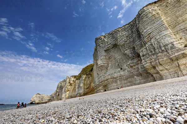 Pebble beach in front of high cliffs with blue sky and sea, The cliffs and alabaster coast of