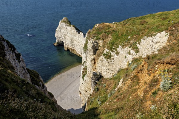 Steep rocks and cliffs with a small hidden beach by the turquoise blue sea, The cliffs and