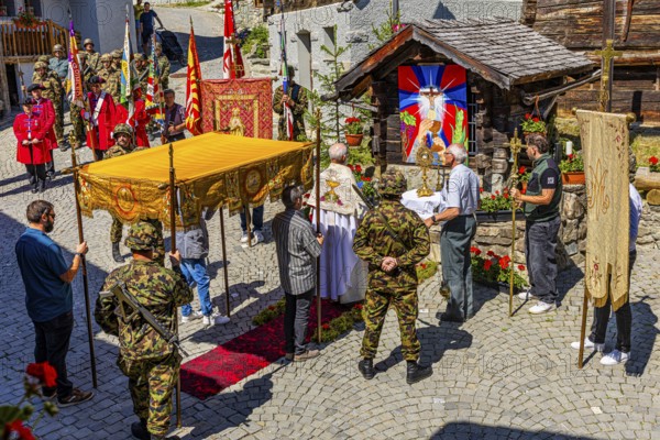The priest celebrates a service at the flower-decorated altar during the Corpus Christi procession,