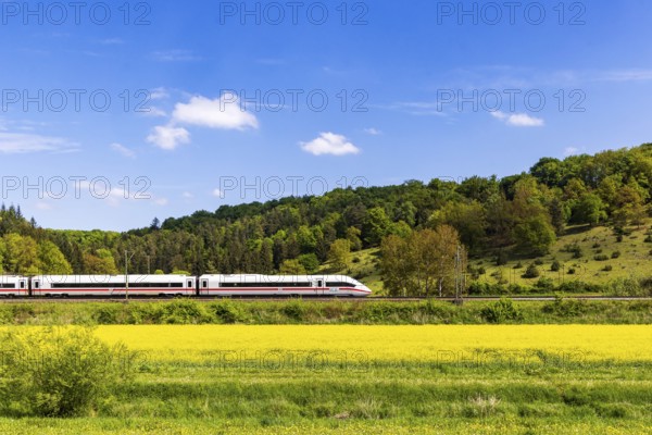 InterCityExpress ICE en route on the Swabian Alb near Lonsee. Landscape on the railway's