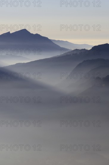 Mountain silhouettes... Alpine peaks and mountain ranges in the Bavarian Alps, light fog rises from