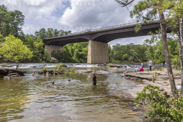 People playing on the rocks under the Little River Falls Bridge in Little River Canyon Falls Park