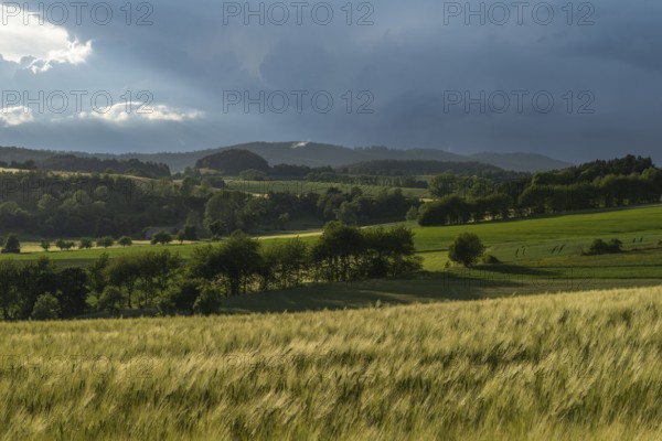 Dramatic cloudy sky with approaching storm and last rays of sunshine, Frankenhain, dark cloud wall,