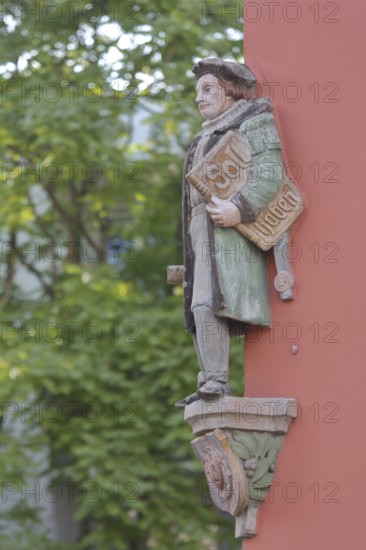 Historical merchant from the 16th century with book and inscription Soll Haben, created in 1933,