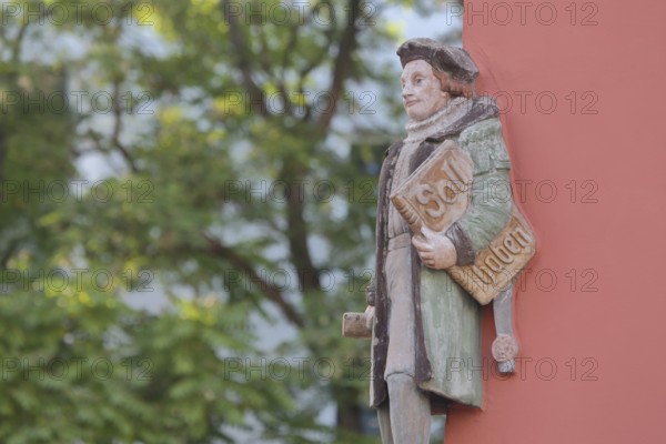 Historical merchant from the 16th century with book and inscription Soll Haben, created in 1933,