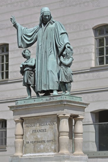 Monument to theologian, pedagogue and poet, August Hermann Francke, man with two children, protect,